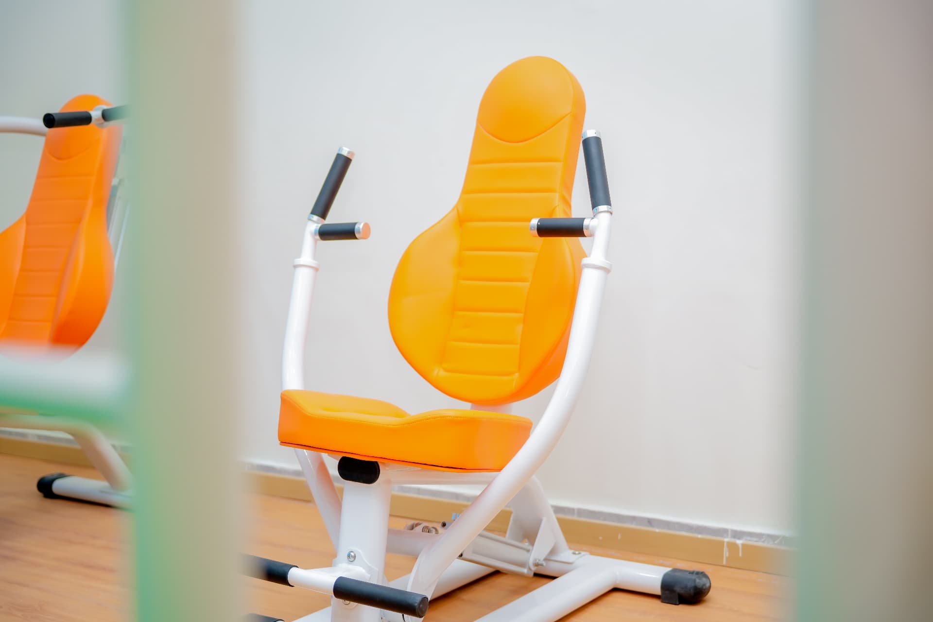 Orange seated strengthening equipment at Rayhan Centre